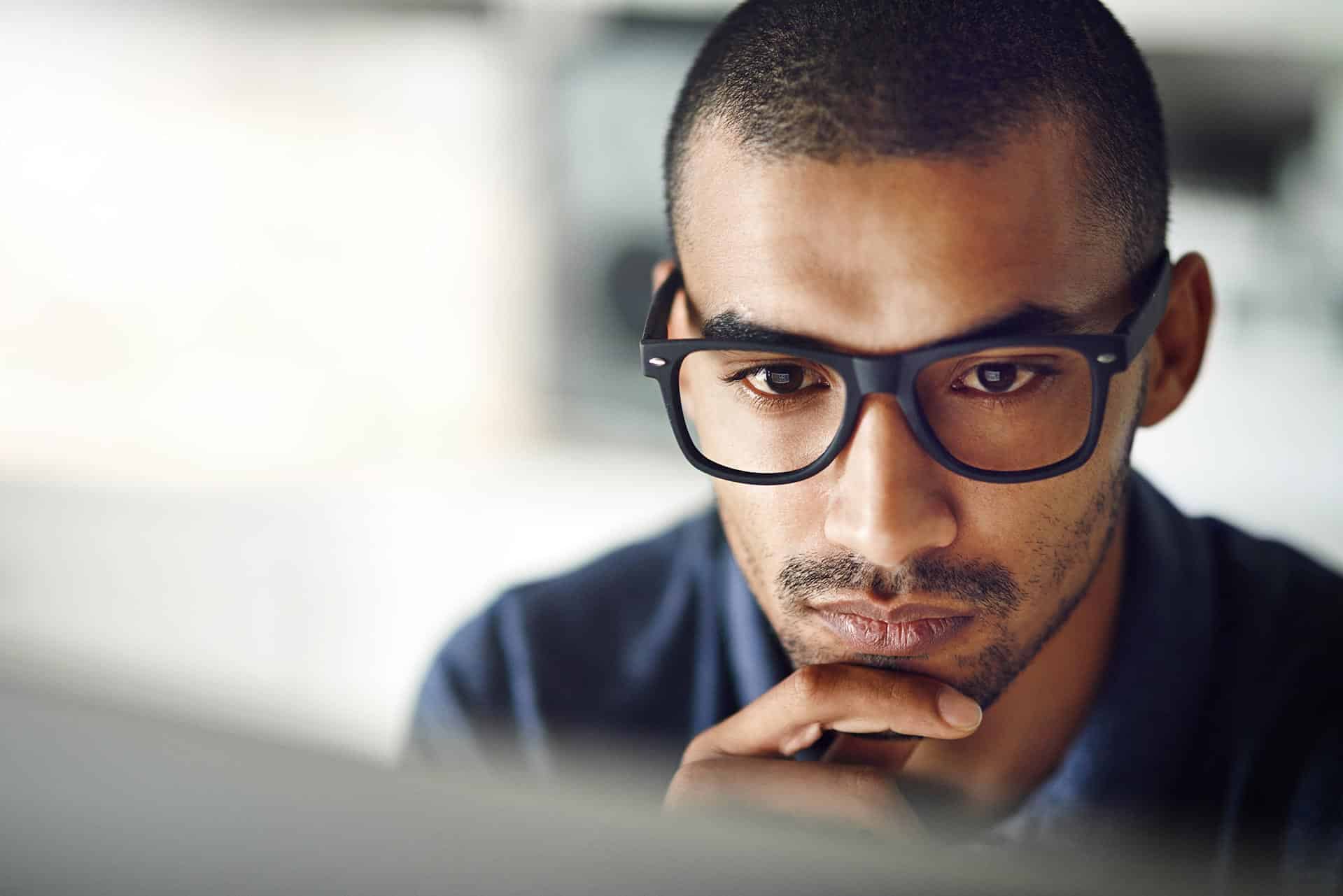Man staring intently at his work with great concentration