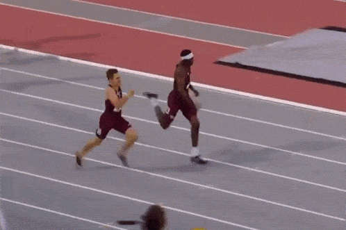 GIF of an athlete running and diving for the finish line to win a race