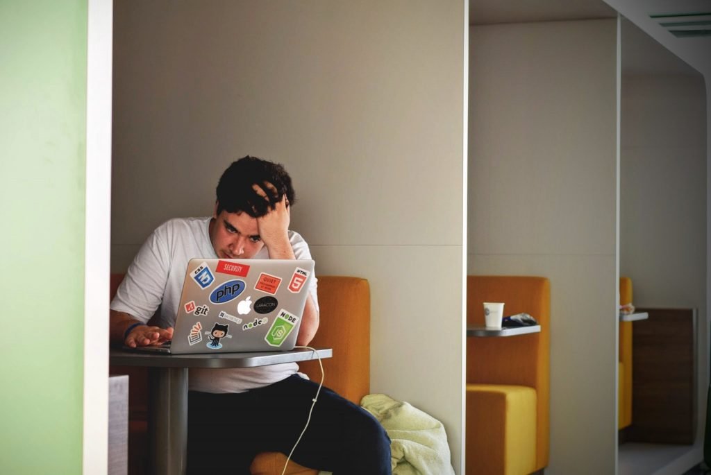 Stressed man working on a laptop