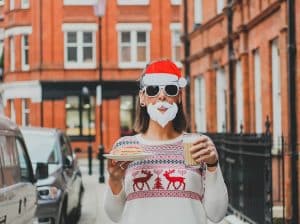 Person in a christmas costume holding a tea and coffee