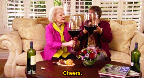 GIF of two old ladies toasting with enormous glasses of red wine