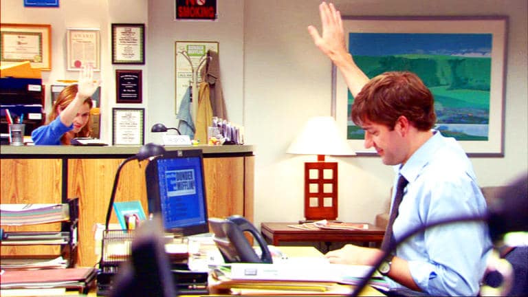 Jim and Pam from the office doing an air high five