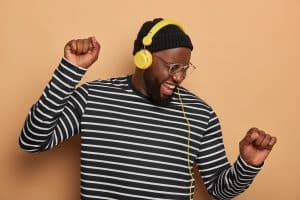 photo of laughing man wearing headphones