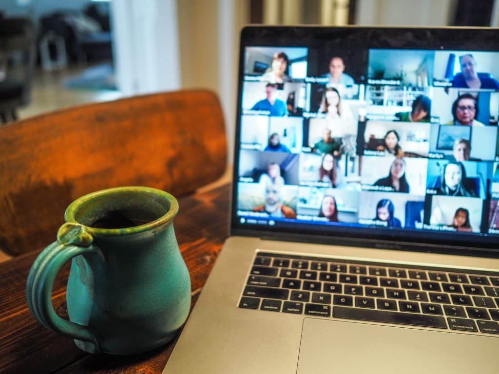 Photo of a laptop with a large Zoom meeting in progress on-screen