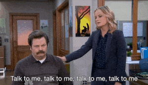 GIF of Lesley Knope bugging Ron Swanson while he tries to ignore her